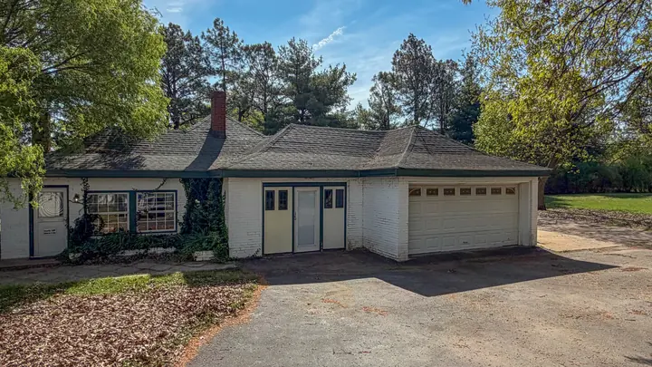 Detached garage and adjoining structure.
