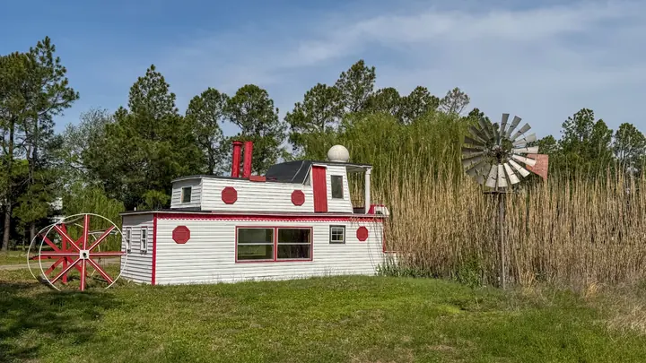 Playful riverboat-style feature beside a windmill.