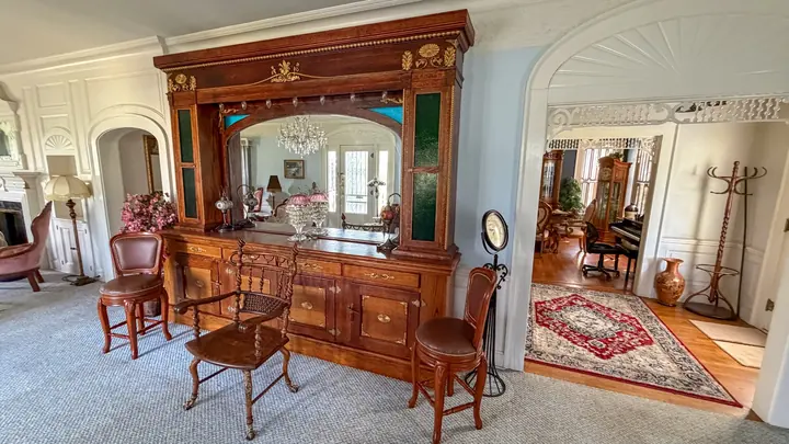 Large wood built-in, mirror, and connecting rooms.