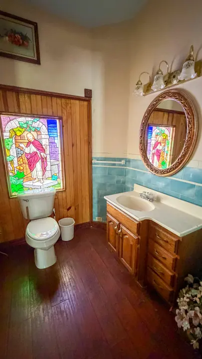 Bathroom featuring stained glass and vintage tile.